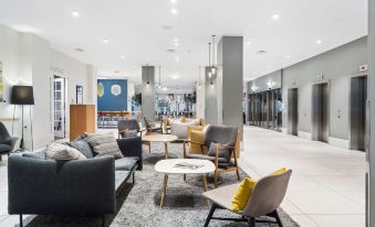 a modern , well - lit lobby with various seating options and furniture , including couches , chairs , and tables at Best Western Plus Airport Hotel Copenhagen