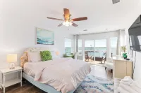 Waterfront home with dock, heated pool, & spectacular views- walk/bike downtown!