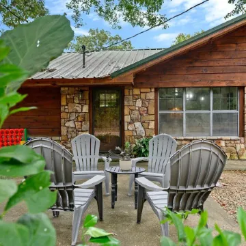 Secluded 4 bedroom farmhouse nestled on 8 acres with large lawn and oak trees.