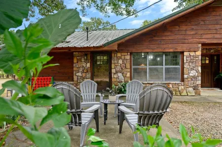 Secluded 4 bedroom farmhouse nestled on 8 acres with large lawn and oak trees.