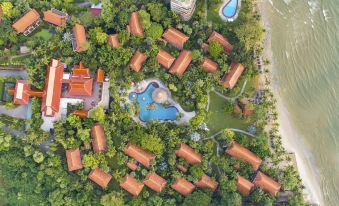 a bird 's eye view of a resort with multiple buildings , a pool , and trees surrounding it at Anantara Hua Hin Resort