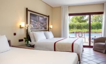 a hotel room with two beds , a window offering a view of the pool , and white bedding at Exe Layos Golf