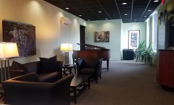 a large , well - lit room with multiple couches and chairs arranged in a comfortable seating area at The Inn at Stone Mill