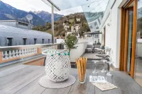 Merano center penthouse with terrace, garage, bike room and infrared sauna.