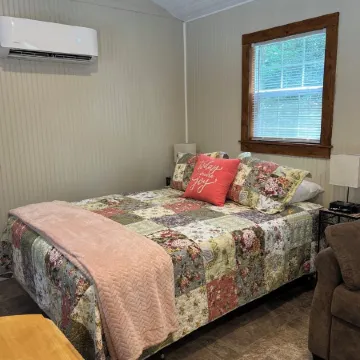 Tiny Cabin in the Laurels, with queen bed & queen sofa bed in wooded setting.