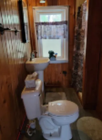 Rustic cabin getaway on the shore of Soo Lake in Phillips, WI