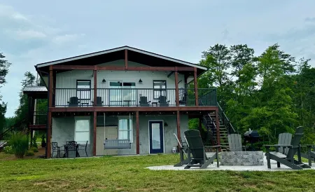 BRAND NEW Lake Front home. Private cove and boat dock! Modern farmhouse appeal!