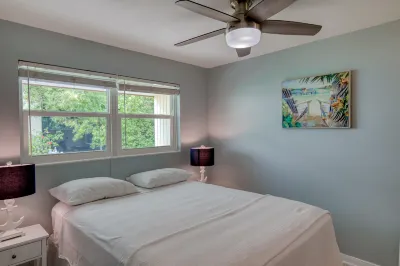 Modern condo near towering palms with beach decor, grill, & yard - walk to beach