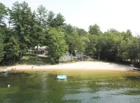 5 bed 4 bath in the Basin of Sebago Lake with 200 ft. of shared beach frontage