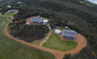 an aerial view of a residential area with two houses and a parking lot in the middle at Nutkin Lodge