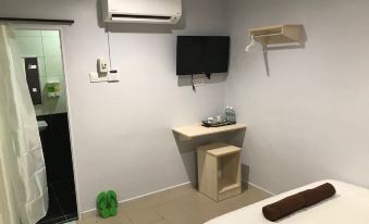 a small hotel room with a bed , a tv , and a mini fridge , as well as a bathroom with a sink at Hotel Seri Kangsar KK Hotel