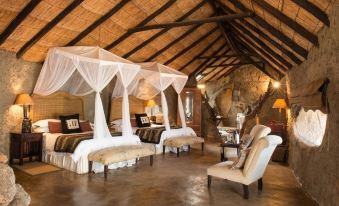 a room with two beds , one on the left side and the other on the right side of the room at Amalinda Lodge