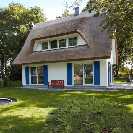 Picturesquely situated thatched-roof house in a large park-like garden