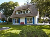 Picturesquely situated thatched-roof house in a large park-like garden