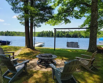NEW! Renovated Bungalow steps from Lake Tomahawk - King Bed, Dock Space, Firepit