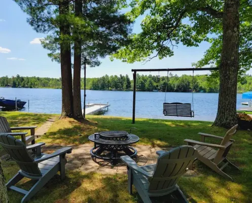 NEW! Renovated Bungalow steps from Lake Tomahawk - King Bed, Dock Space, Firepit