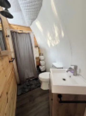 Cozy lakeside glamping dome with fireplace, AC and full bath.