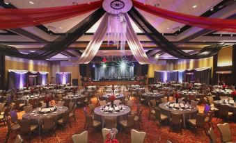 a large banquet hall filled with round tables and chairs , ready for a formal event at Four Winds Casino Resort – New Buffalo