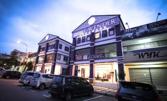 "a building with a purple and white facade has a sign that says "" rillufer ""." at Hotel Lavender Senawang