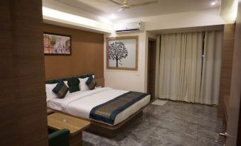 a large bed with a white and brown comforter is in the middle of a room with marble floors at The Heritage