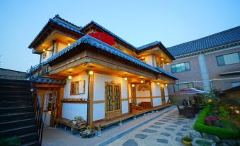 The front view at night showcases a restaurant and other buildings in an old section at Jeonju Dwaejikkum Hanok