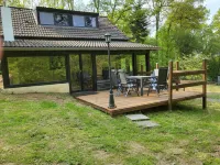 House in the forest with fenced garden