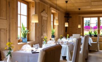 a dining room with tables and chairs set up for a formal dinner , possibly a wedding reception at Adler Spa Resort Dolomiti