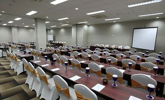a large conference room with multiple tables and chairs arranged for a meeting or event at Sakura Park Hotel & Residence