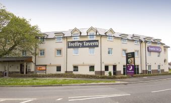"a large building with the name "" trefry tavern "" on it , located on a street with trees and other buildings in the background" at Premier Inn Newquay (Quintrell Downs)