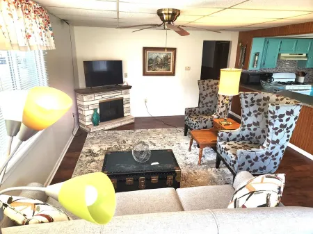 Open concept 2 bedroom ranch with attached garage and deck