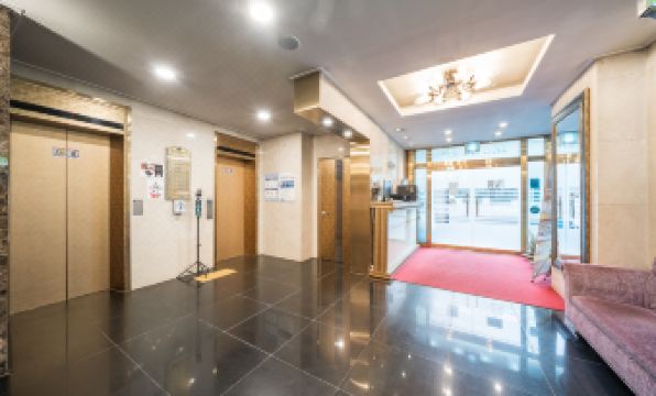 a hotel lobby with two elevators , one on the left side and the other on the right side at Symphony Hotel