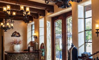 a room with a stone counter and a chandelier hanging from the ceiling , leading to a doorway at Tubac Golf Resort & Spa