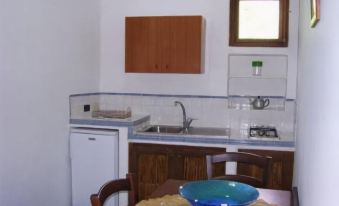 a kitchen with a dining table and chairs , as well as a sink and refrigerator at Sweet Home