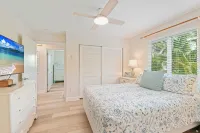 Charming cottage with heated pool, tropical landscaping in prime location.