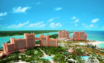 aerial view of a tropical resort with tall buildings , a beach , and the ocean in the background at The Royal at Atlantis