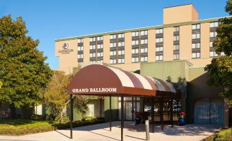 "a large hotel building with a sign that reads "" grand ballroom "" prominently displayed on the front" at DoubleTree Boston North Shore Danvers