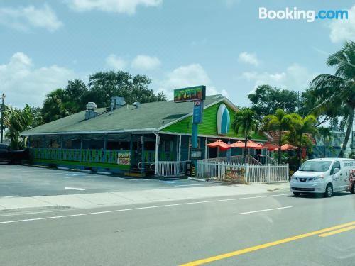 a dining table with two wine glasses and a bottle of champagne , as well as several other bottles on the table at Madeira Beach 2 Bedroom, 1 Bath 230