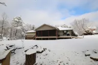 This charming  cozy cottage has a private hot tub, deck for fishing.