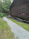 Beautiful cabin situated on wooded land with nice yard clearing and small stream