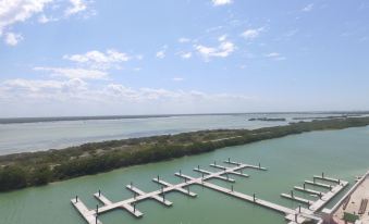 aerial view of a large body of water with multiple boats docked at a marina , surrounded by trees at Villas Grand Marina Kinuh