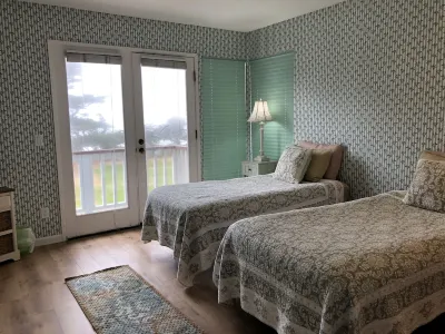 Beachfront home directly across from beach & park! Close to everything!