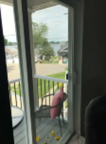 View of Lake Fenton with hot tub and fire place