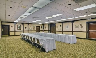 a large conference room with multiple tables and chairs arranged for a meeting or event at Hotel Veranda DuBois