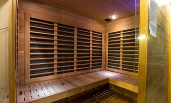 a wooden sauna room with multiple benches and shelves , giving it an open and airy feel at Maruia Hot Springs