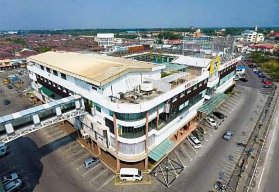 an aerial view of a large shopping mall with multiple floors and cars parked in the lot at Hotel Sfera