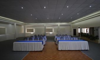 a large conference room with multiple tables and chairs arranged for a meeting or event at Hotel Mirage