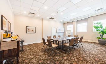 a large conference room with several chairs arranged in a circle around a dining table at Hotel Santa Barbara