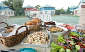 a dining table filled with a variety of food items , including sandwiches , salads , and other dishes at Amalfi Resort