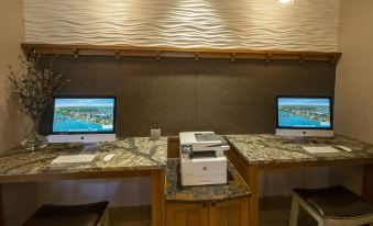 a modern office space with two computer workstations , each equipped with a printer and two monitors at Chautauqua Harbor Hotel - Jamestown