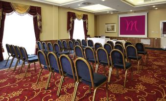 a large conference room with rows of chairs arranged in a semicircle , ready for a meeting or event at Letchworth Hall